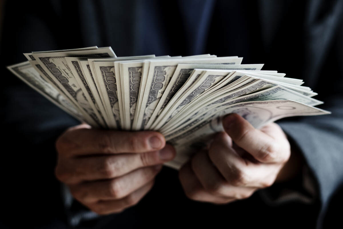Holding Hundred Dollars Bills in Hands