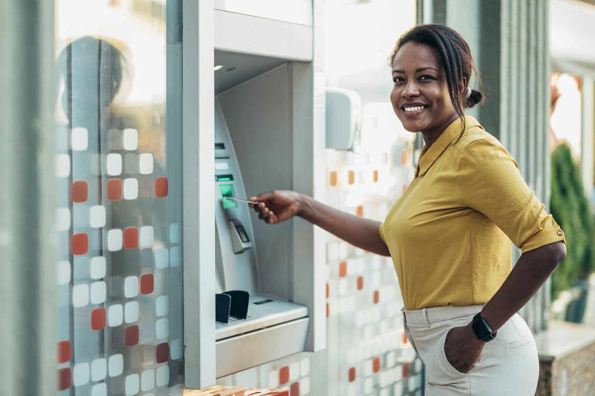 smiling woman using an atm machine